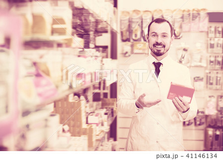 Cheerful male pharmacist suggesting useful drug 41146134