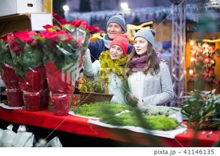 Charming family of three choosing floral decorations 41146135