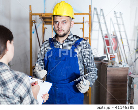 Professional worker with spatula is clarifying details from client Professional worker with spatula is clarifying details from client 41146389