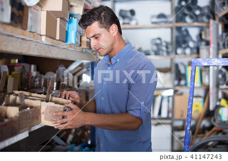 consultant is checking small details in boxes 41147243