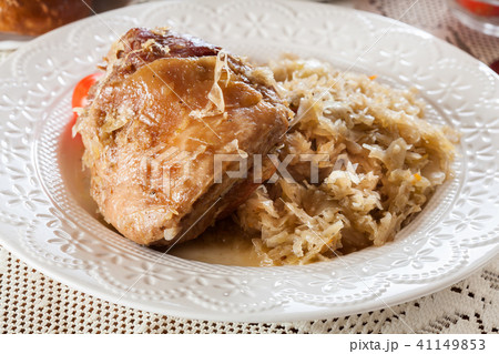 Pork knuckle with fried sauerkraut and tomatoes 41149853