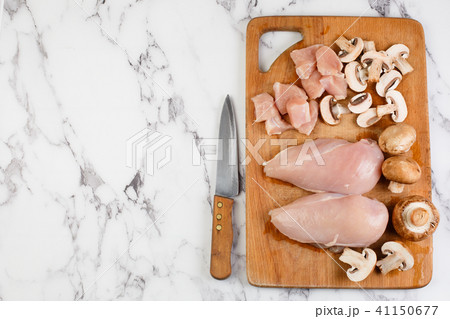 raw chicken fillets on wooden cutting board 41150677