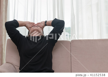 Depressed young woman sit on sofa 41152538
