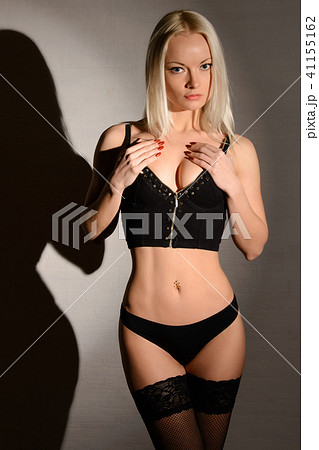 Sensual lady posing in panties stockings and bra - Stock Photo