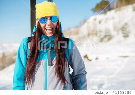 Picture of sports girl with skis and sticks in winter 41155586