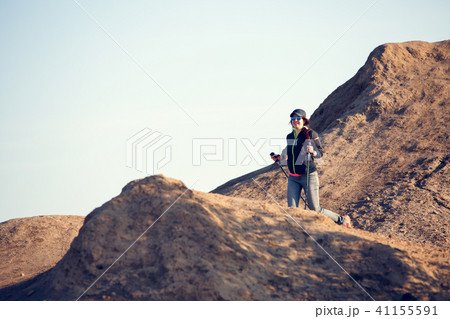 Image in full growth of tourist girl with backpack and sticks for walking on mountain 41155591