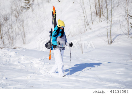 Photo of sporty woman with skis and sticks in winter 41155592