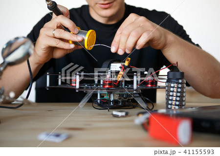 Image of engineer with soldering iron repairing mechanism 41155593