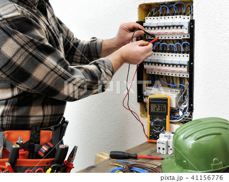 Electrician technician at work on a electric panel 41156776