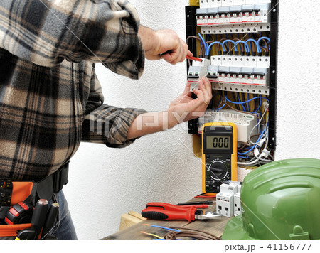 Electrician technician at work on a electric panel 41156777