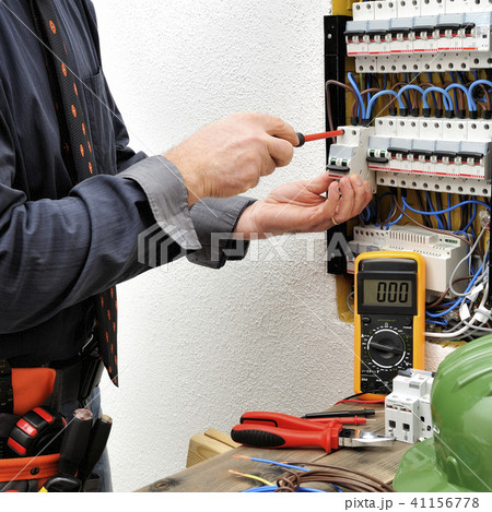 Elegant electrician at work on a electric panel 41156778