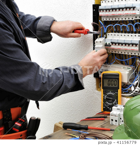 Elegant electrician at work on a electric panel 41156779