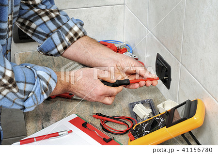 Electrician at work on a electric system 41156780