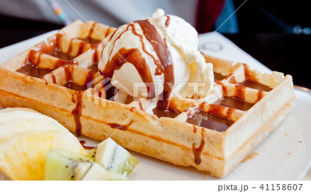 Vanilla sweet ice cream on top of brown waffle 41158607