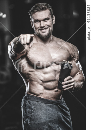 Brutal strong bodybuilder athletic men pumping up muscles with d Brutal strong bodybuilder athletic men pumping up muscles with d 41158885