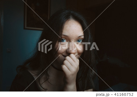 girl smiling shyly with her hand on her lips girl smiling shyly with her hand on her lips 41160752