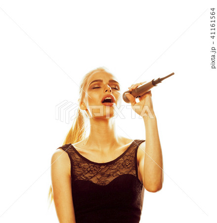 young pretty blond woman singing in microphone isolated close up young pretty blond woman singing in microphone isolated close up 41161564