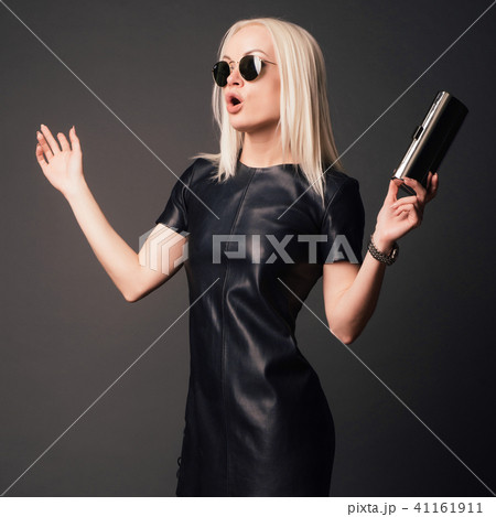 stylish woman in black dress with small silver bag stylish woman in black dress with small silver bag 41161911