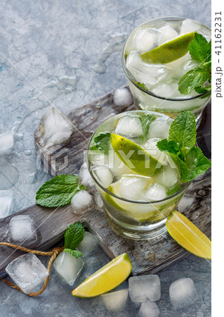 Lemonade with mint, lime slices and ice cubes. Lemonade with mint, lime slices and ice cubes. 41162231