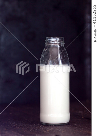 Bottle with milk on a dark background, retro style 41162855