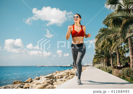 Glad young woman running in the nature 41168495
