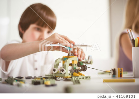 Serene child creating plastic helicopter Serene child creating plastic helicopter 41169101