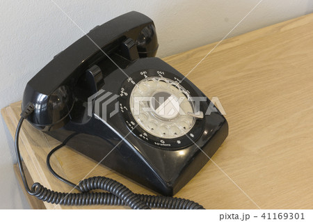 Vintage black telephone on wooden table. 41169301