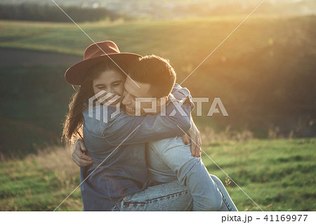 Loving young people hugging on green hill Loving young people hugging on green hill 41169977