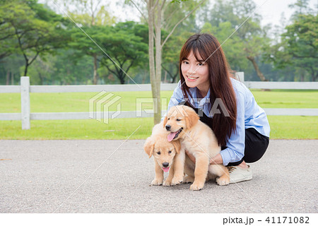 Beautiful asian girl with her little dogs in park Beautiful asian girl with her little dogs in park 41171082