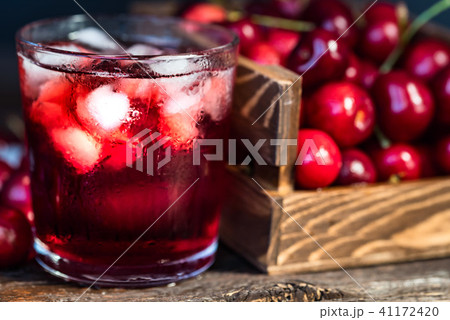 Fresh cherries in a wooden box, ice, cherry juice 41172420