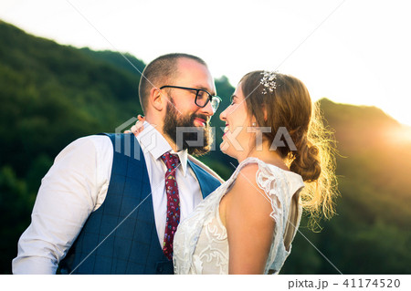 Bride and groom hugging at romantic sunset Bride and groom hugging at romantic sunset 41174520