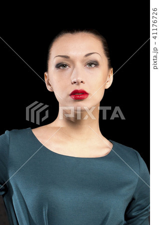 Pretty Girl on high heels poses in studio on black background with red lips Pretty Girl on high heels poses in studio on black background with red lips 41176726