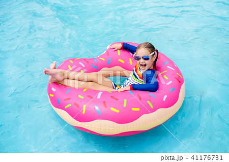 Child in swimming pool on donut float 41176731