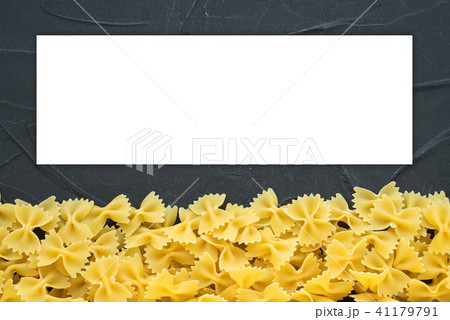 farfalle macaroni Beautiful decomposed pasta with a bottom on a black textured background. Close-up farfalle macaroni Beautiful decomposed pasta with a bottom on a black textured background. Close-up 41179791