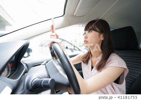 スマホを使いながら運転する女性 スマホを使いながら運転する女性 41181755