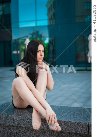 young trendy girl sitting near skyscraper young trendy girl sitting near skyscraper 41182955