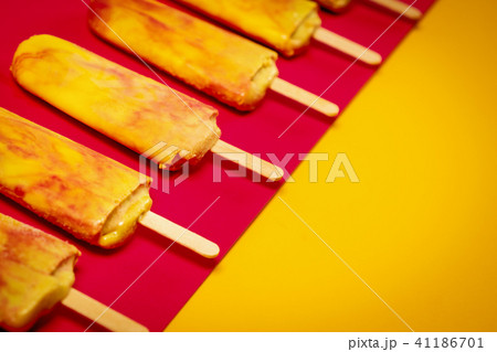 isolated yellow-red ice cream on a colorful background 41186701