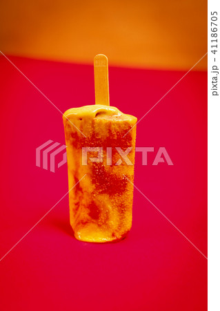 wasted delicious yellow-red ice cream on a red background 41186705