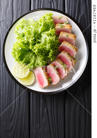 seared ahi tuna in breading with lettuce and lime seared ahi tuna in breading with lettuce and lime 41187469