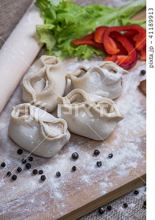 Making of homemade dumplings pastry tortellini or ravioli. Model for home made pasta filled with Making of homemade dumplings pastry tortellini or ravioli. Model for home made pasta filled with 41189913