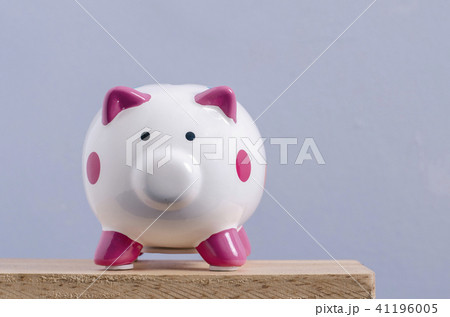 saving concept, white piggy bank on wooden desk saving concept, white piggy bank on wooden desk 41196005