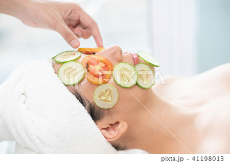 Woman gets eye and facial skin nature treatment. 41198013