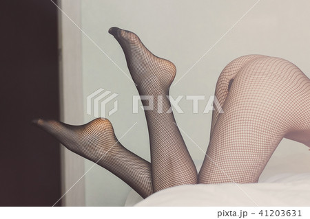Women`s Used Nylon Pantyhose on the Bed. Fetish Stock Photo