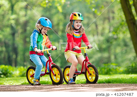 Kids ride balance bike in park 41207487