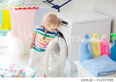 Child in laundry room with washing machine Child in laundry room with washing machine 41207498