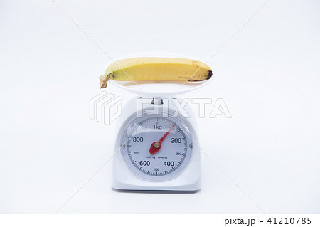 Bunch of bananas on scales isolated on white Bunch of bananas on scales isolated on white 41210785