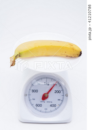 Bunch of bananas on scales isolated on white Bunch of bananas on scales isolated on white 41210786