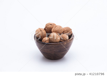 Walnuts in wooden bowl isolated on white backgroun 41210796