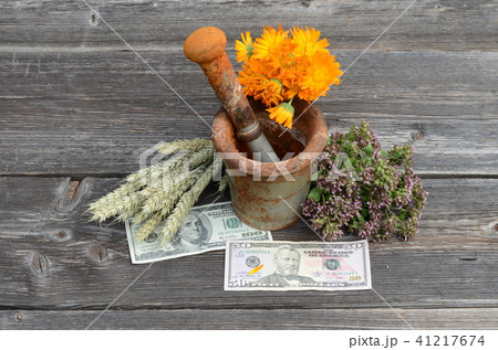 ancient mortar and various herbs with dollar money ancient mortar and various herbs with dollar money 41217674