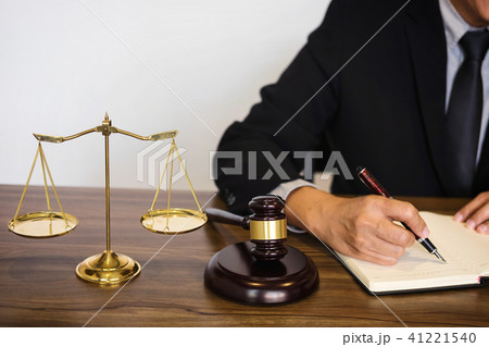 Judge gavel with scales of justice, male lawyers working having 41221540